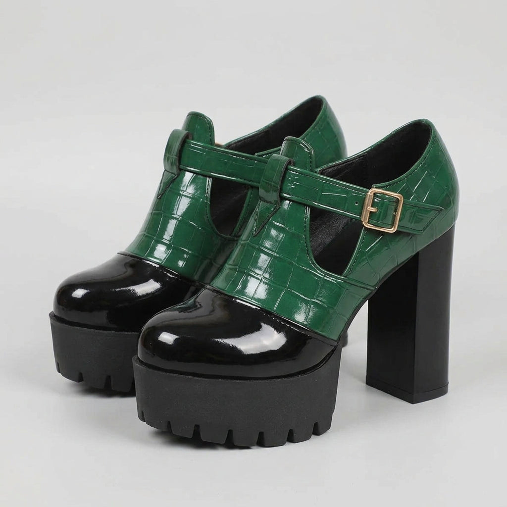 A pair of green and black platform pump shoes with chunky heels and a square toe style.