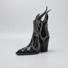 Black studded ankle boot with flame design on a white background